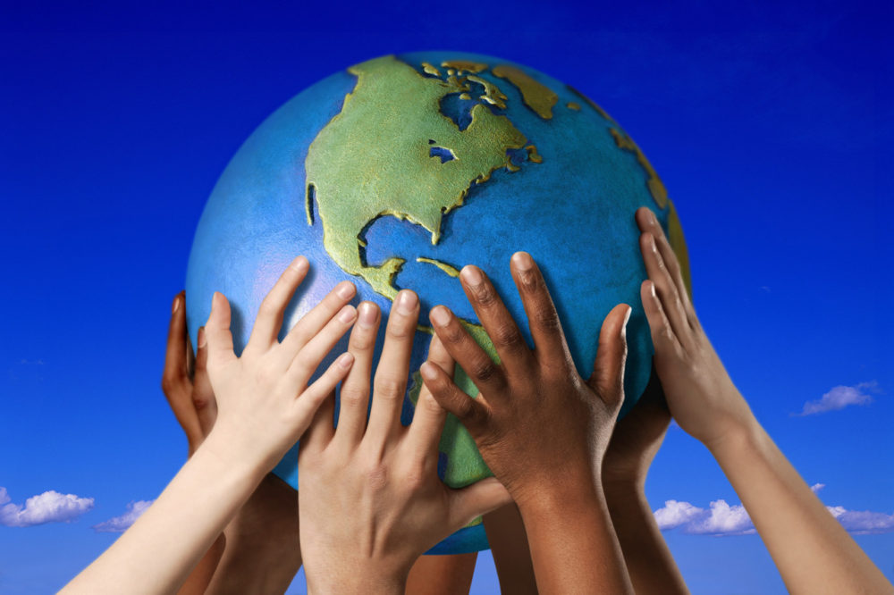 Hands on a globe --- Image by © Royalty-Free/Corbis