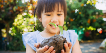 Child with little plant sprout